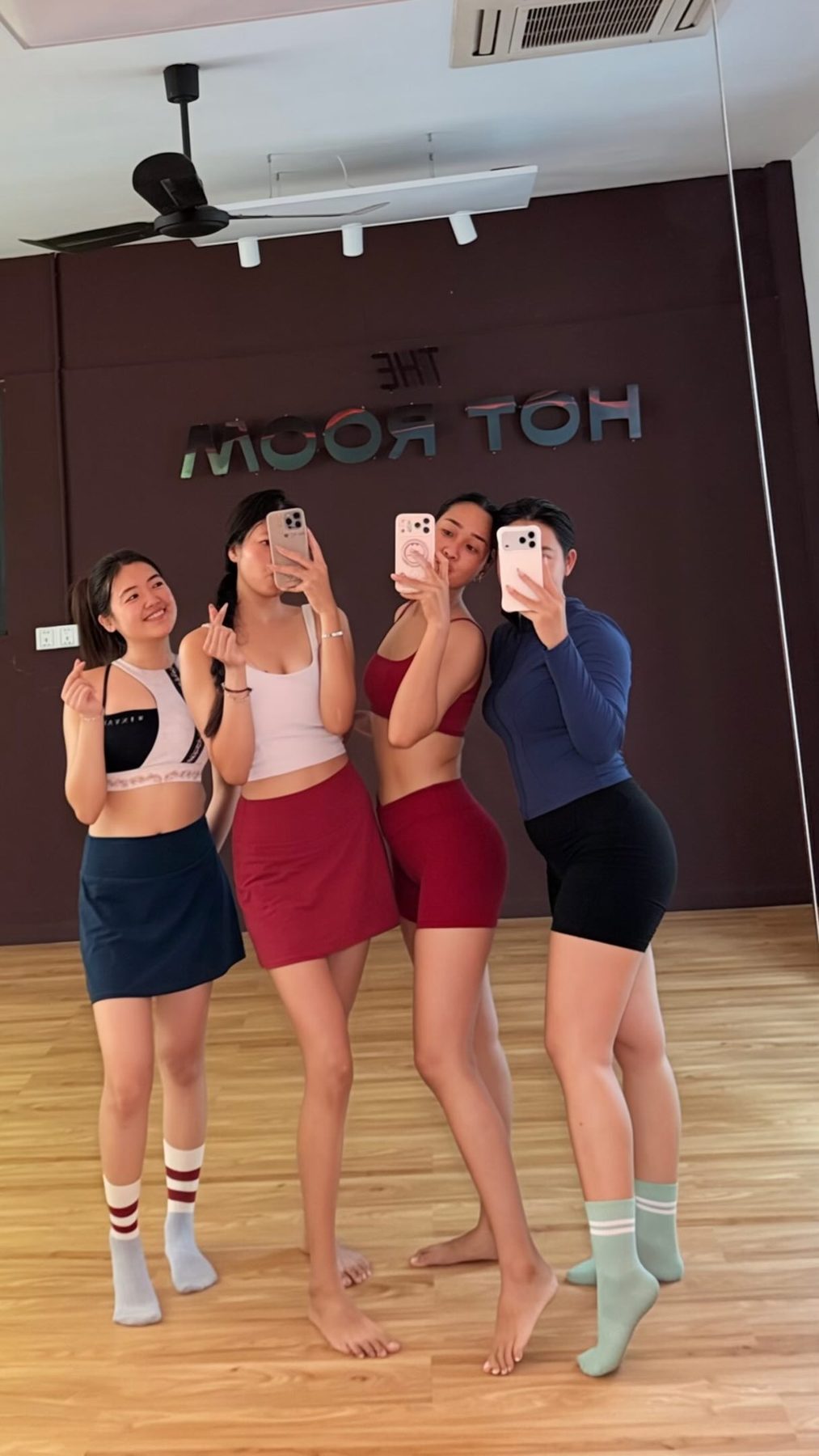 Four friends in socks taking a mirror photo after a Hot Room class